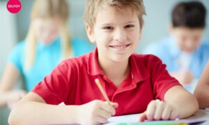 does autodidact work with self care? boy wearing red t shirt smiling having pen and notebook in his hand