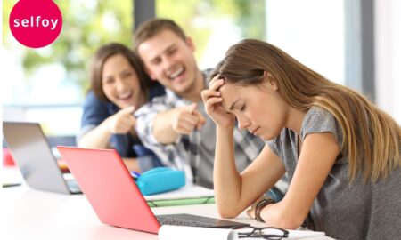 two guyz are teasing one girl that shows outside influences that affect self esteem come from environment